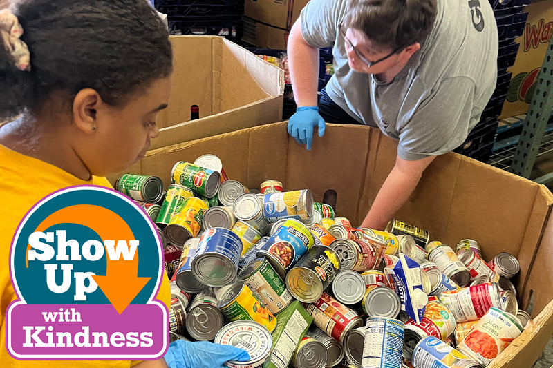 Two people looking through canned goods