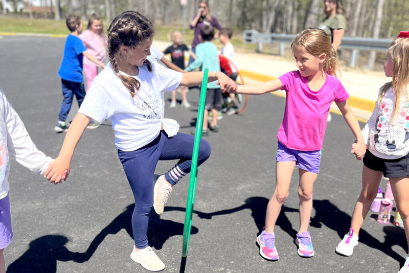 Young students holding hands in a game