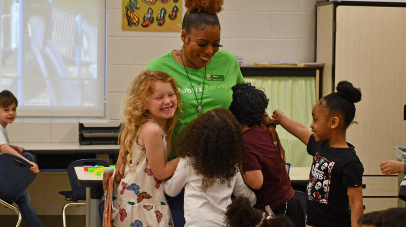 Students hugging a teacher