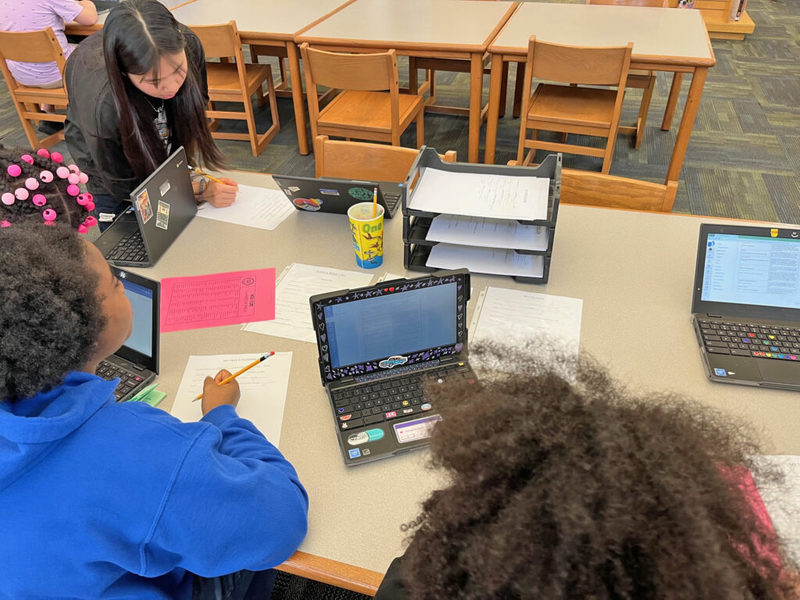 Students writing at desk