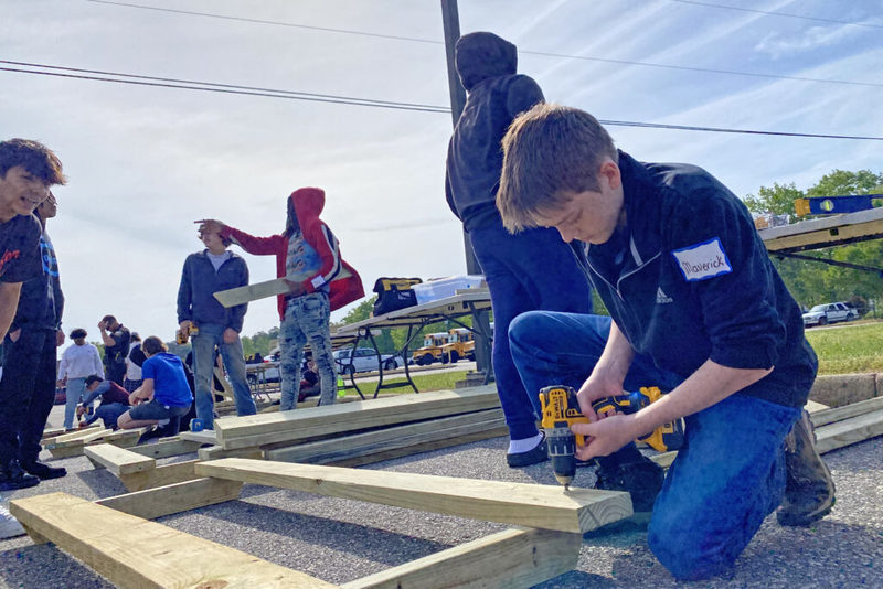 Student drilling into lumber