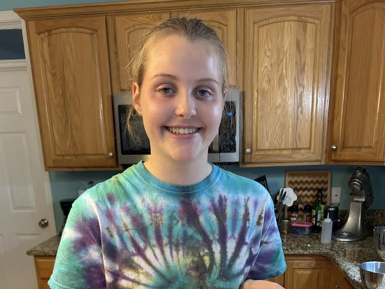 Student smiling in kitchen