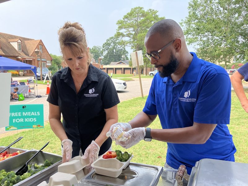 Two adults preparing a boxed meal