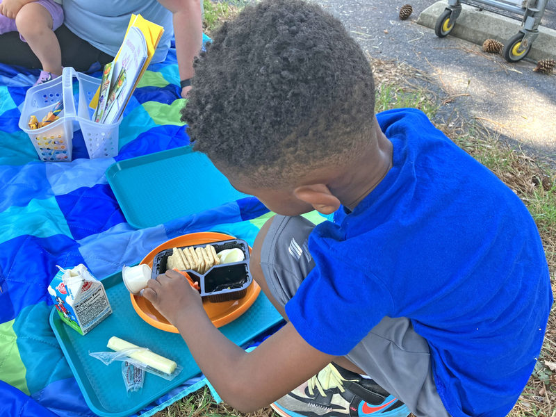 Student eating from boxed lunch