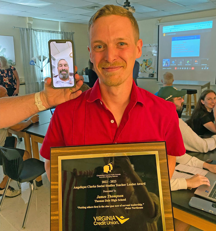 Man smiling and holding award