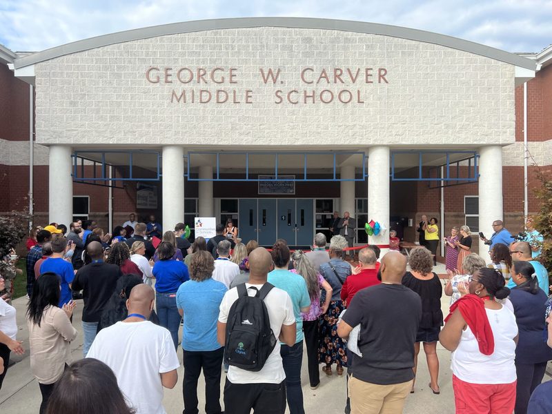 Crowd gathered around entryway to school